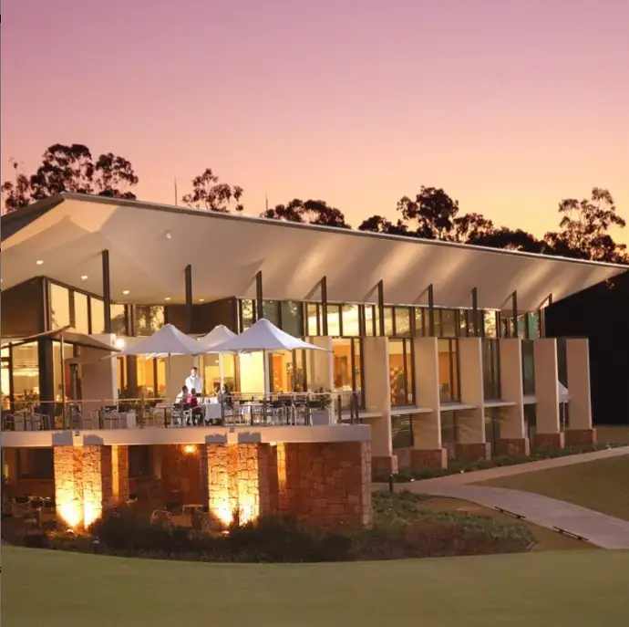 An outdoor dining area of a restaurant with a sunset in the background | Featured Image for the Country Club and Golf Course | Brookwater Golf and Country Club home page